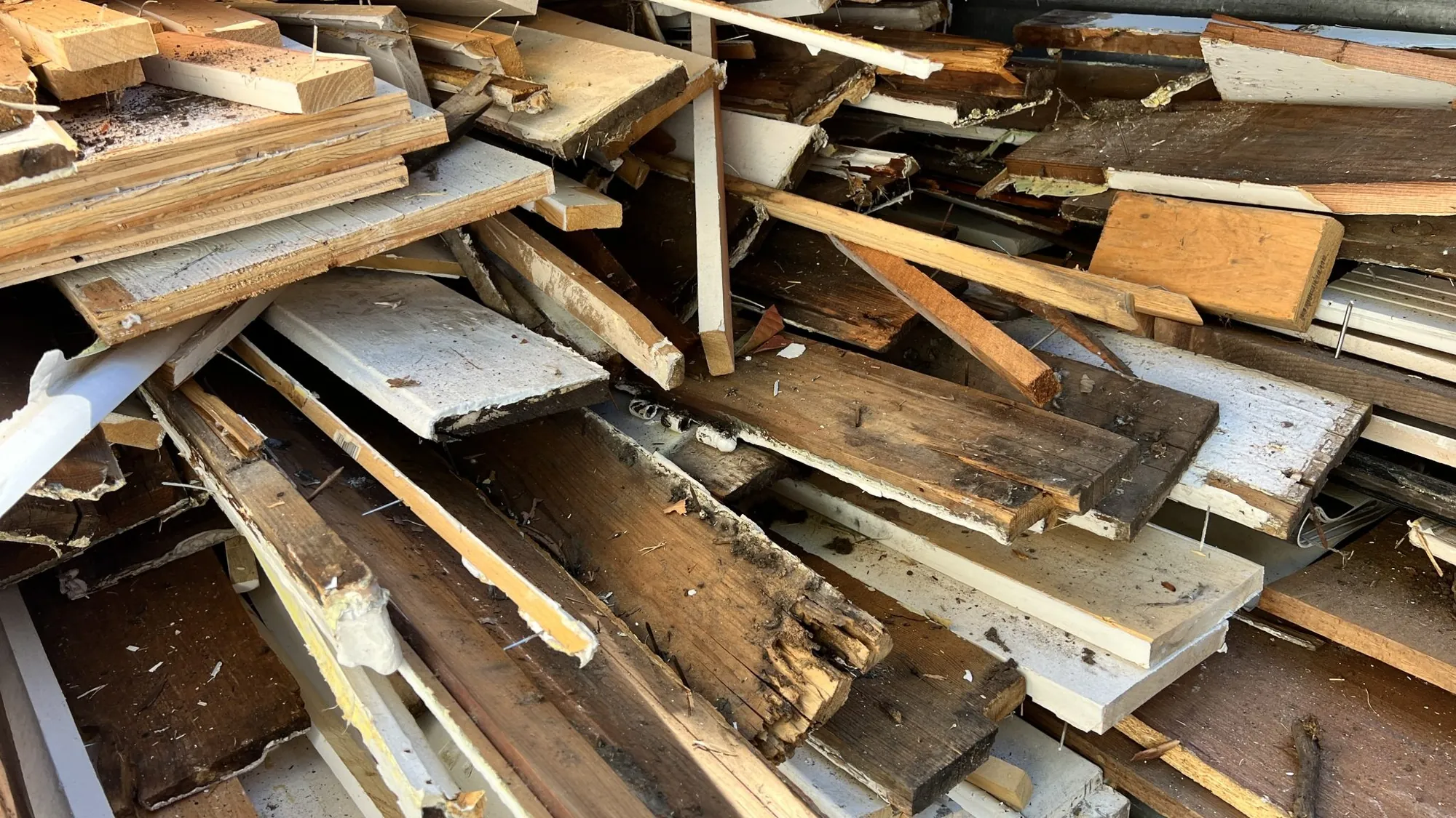 Pile of old boards and trim pulled out during a renovation